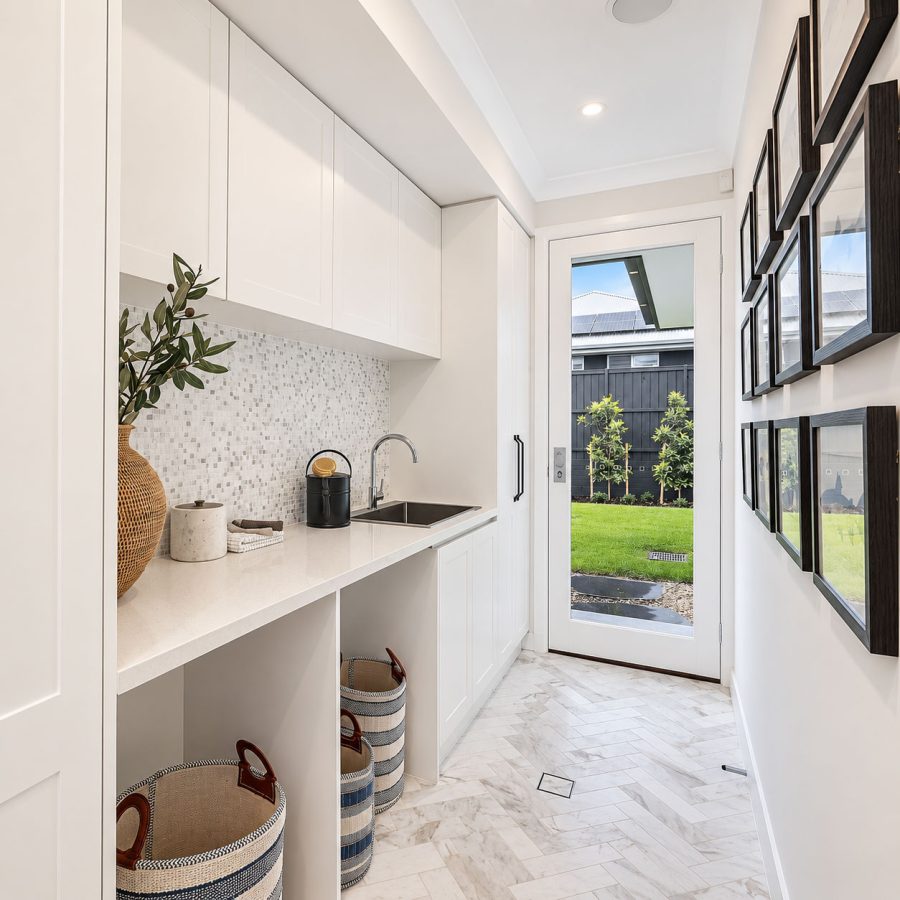 Brighton laundry renovation with custom cabinetry and herringbone tile floor